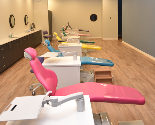 Row of multi colored dental treatment chairs