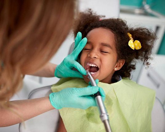 Child’s teeth are being polished