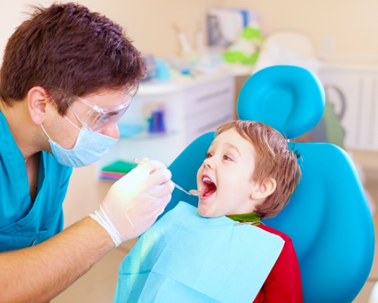 Child receiving preventive dentistry treatment