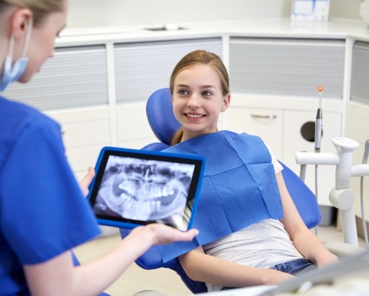 Pediatric dentist looking at digital x-rays