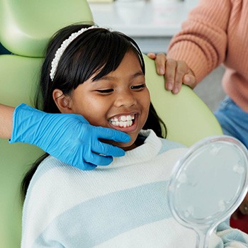 Young smiling girl at dentist