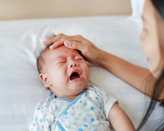 Baby crying before lip and tongue tie treatment