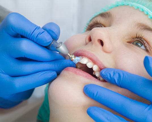 Child receiving fluoride treatment