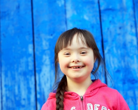 Child smiling after special needs dentistry visit