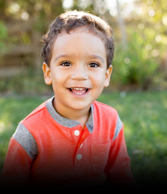 Child sharing healthy smile after preventive dentistry visit