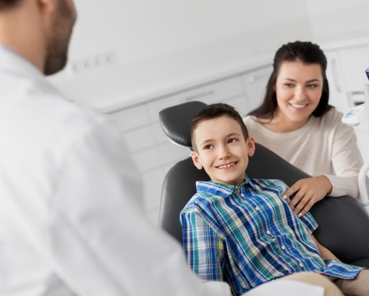 Mother and child talking to pediatric dentist