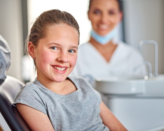 Child smiling while visiting a pediatric dentist