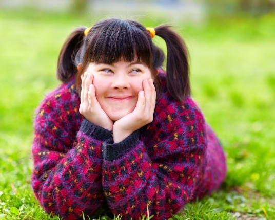 Young girl smiling outdoors