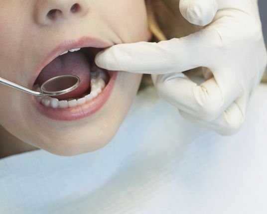 Child receiving an exam for interception orthodontics