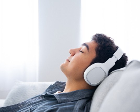 teen boy relaxing following wisdom tooth extraction    