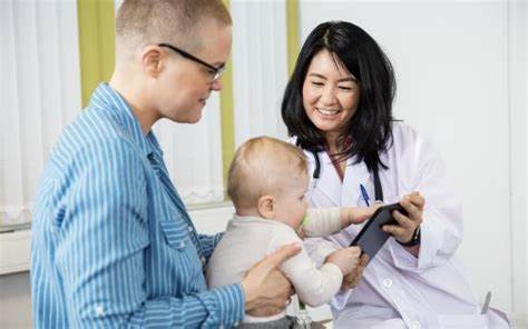 parent learning about tongue tie issues with baby at dentist 