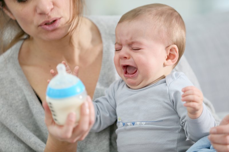 A crying baby with lip or tongue-ties