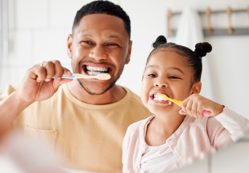 Dad and daughter brushing teeth