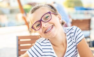 Child smiling with braces.